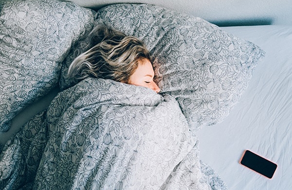 Woman sleeps in bed