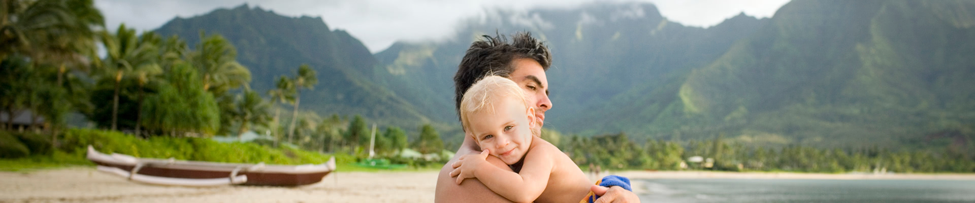 Man and child on beach in Oahu