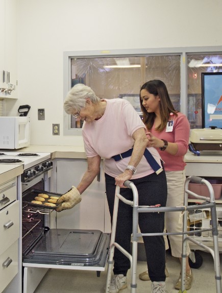 elderly woman at oven