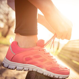 Fitness Trail: Person tying their shoe on a bench